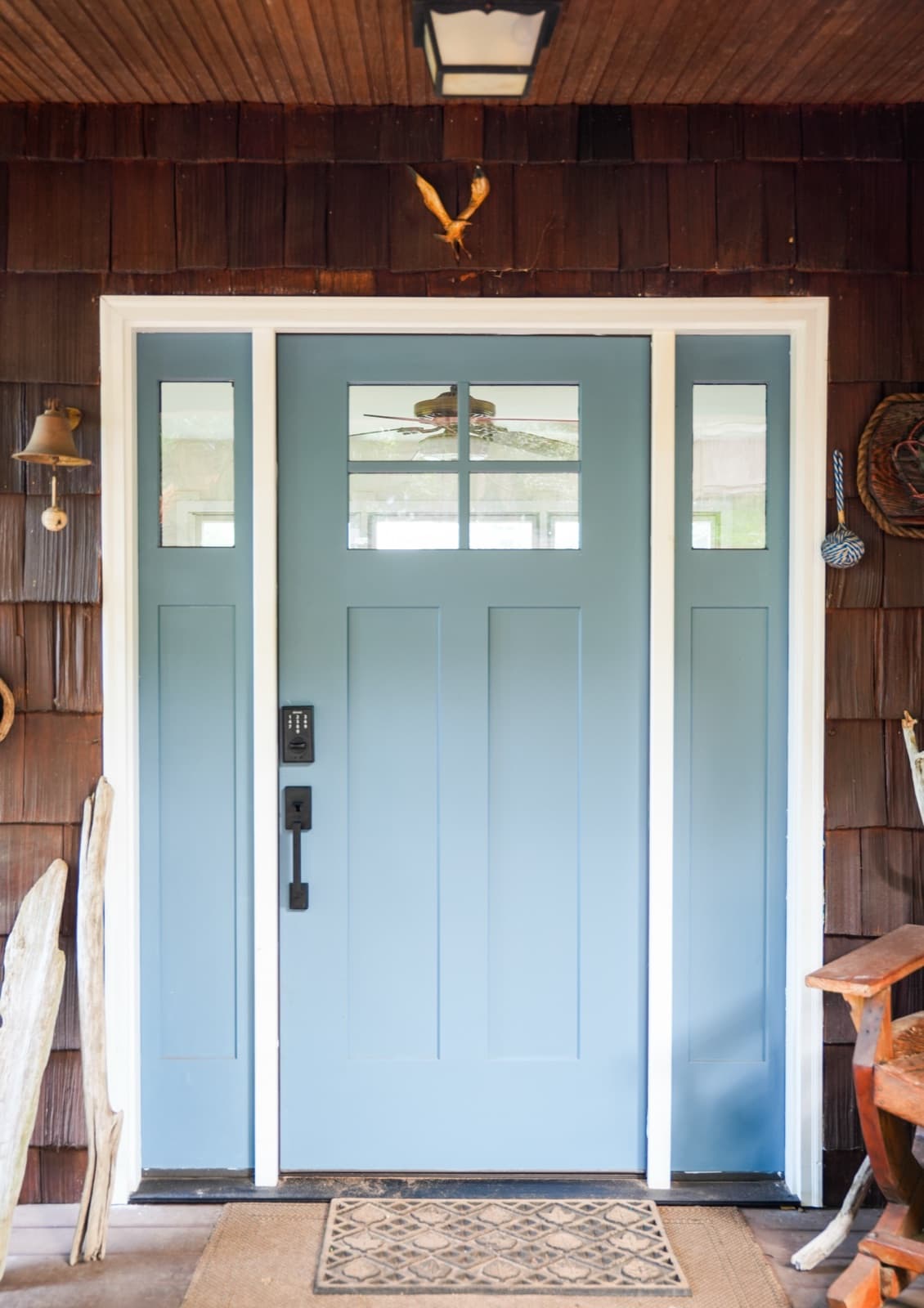 Slate-blue craftsman entry door with sidelites on a cedar-shingled Shore home